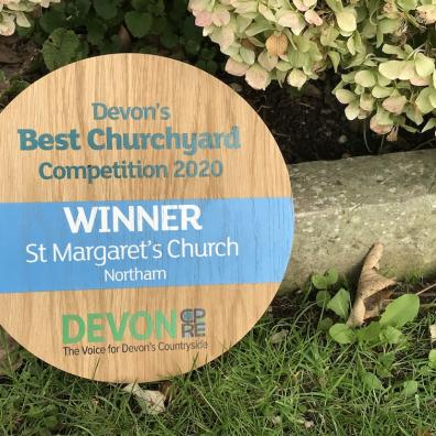 Devon's Best Churchyard 2020 winner's plaque in the churchyard at Northam