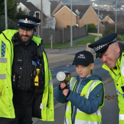 Two policeman with child and traffic speed gun