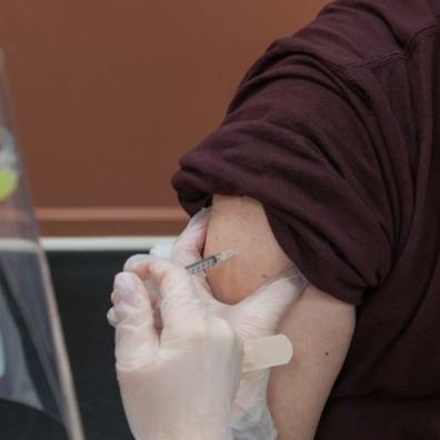 An image showing a person receiving a vaccination jab in the arm